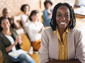 woman standing in front of other people who are seated